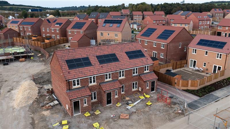Picture of new build houses with solar panels on top